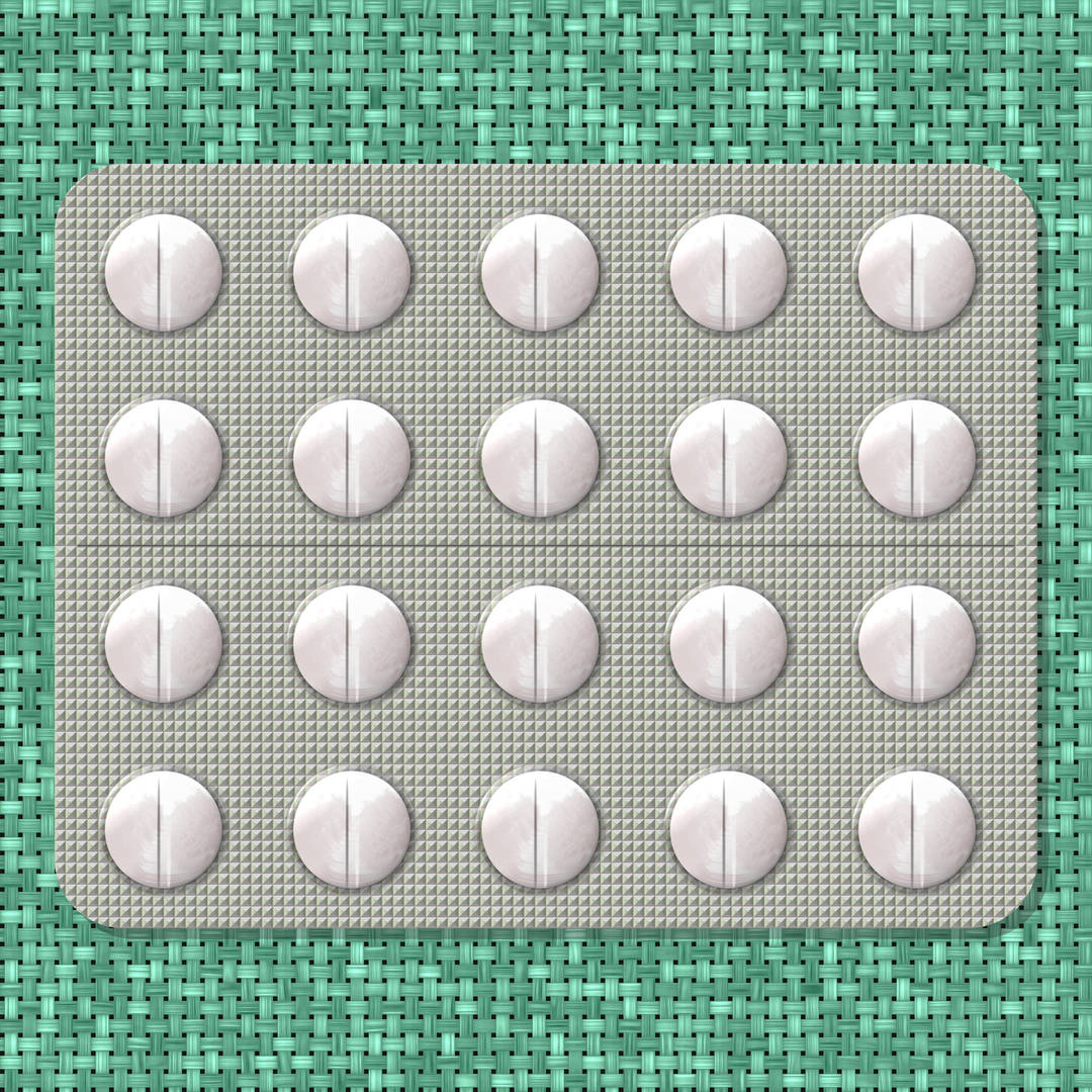 pills on green textured background
