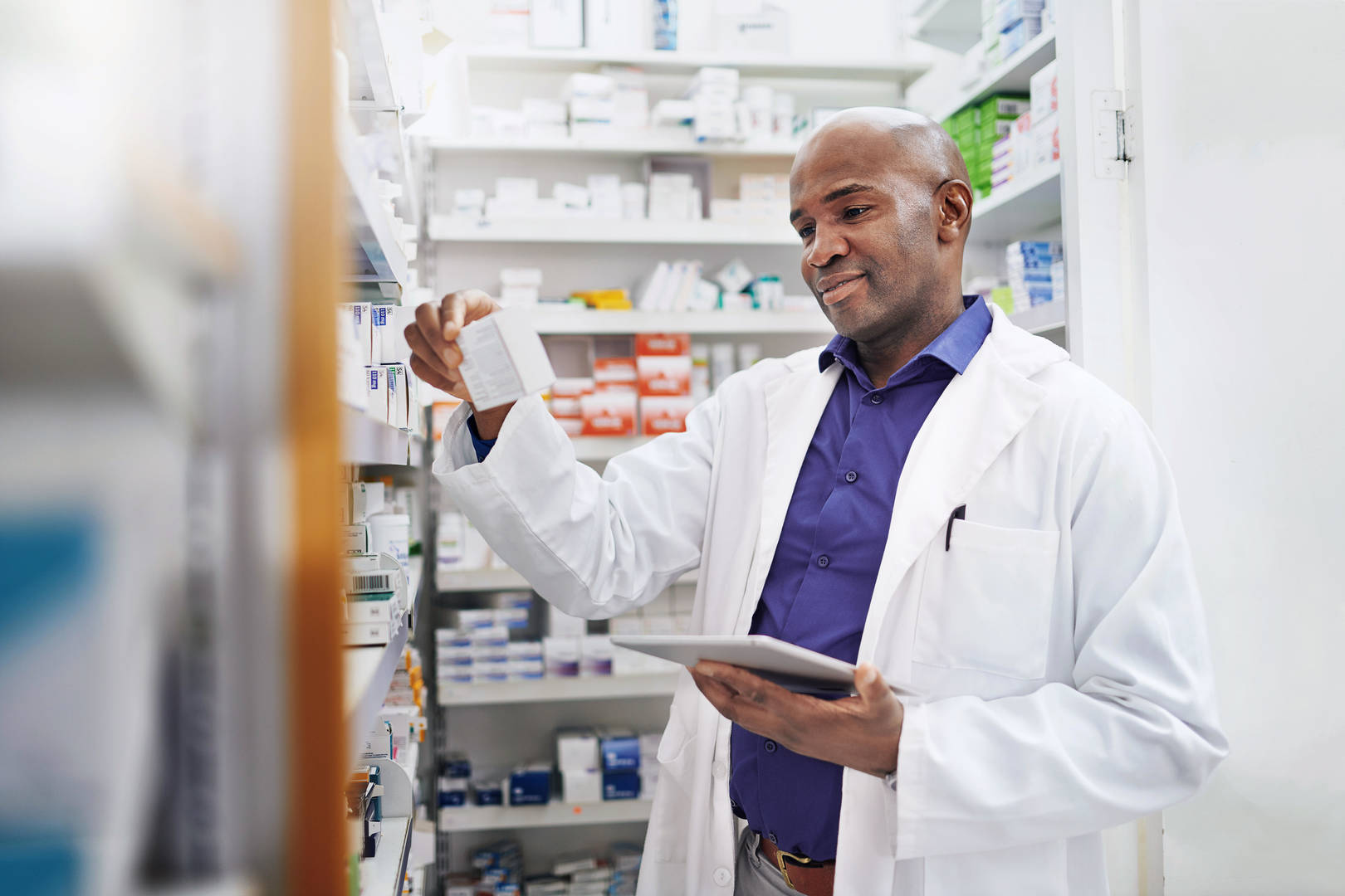 Cropped shot of a pharmacist using a digital tablet in a chemist