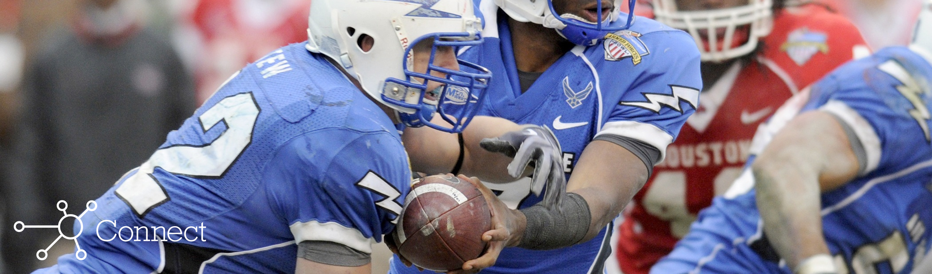 A quarterback handing off a football to a running back