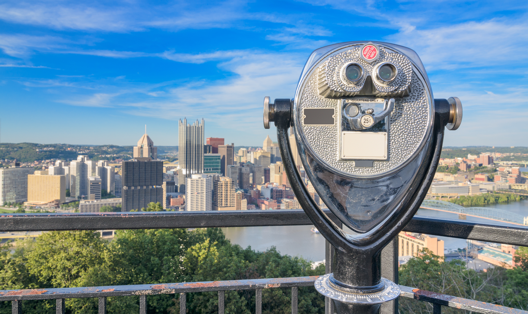 Rooftop binoculars looking out over a city