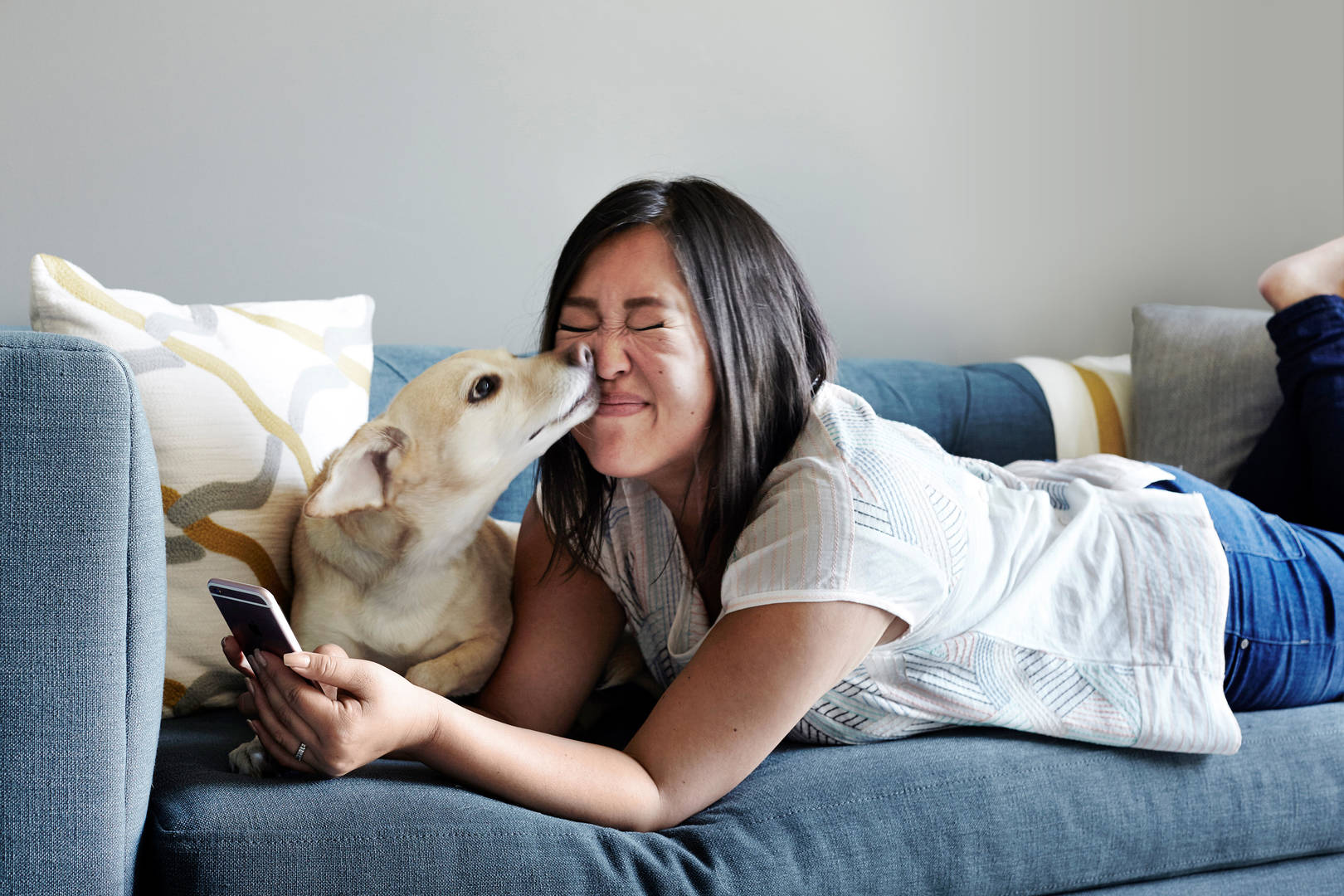 Asian woman texting with dog